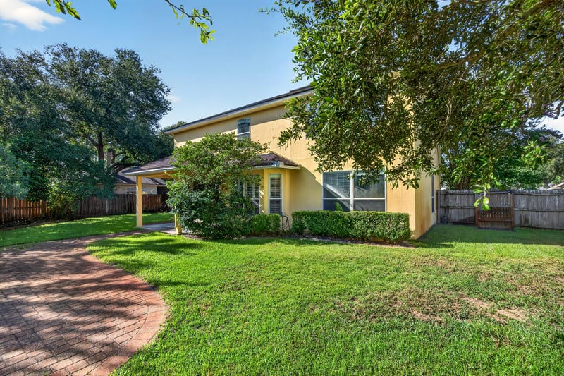 Rear exterior with backyard lawn and trees at 470 Sparrow Branch Cir, Jacksonville, FL 32259
