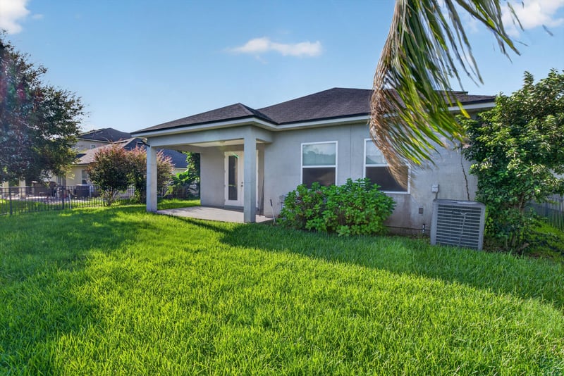 Rear exterior covered patio and backyard at 13685 Goodson Pl, Jacksonville, FL 32226