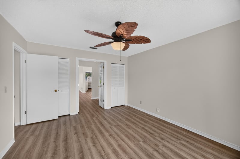 Hallway with wood floors and ceiling fan at 3407 Fairbanks Grant Rd N, Jacksonville, FL 32223