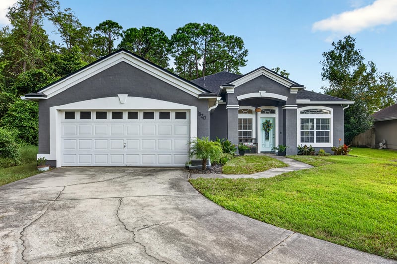 Front exterior wide view with driveway at 1820 Burgess Hill Dr E, Jacksonville, FL