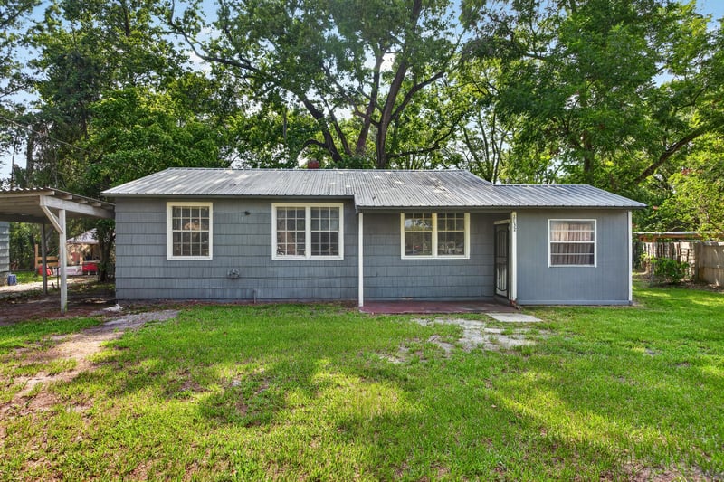Front exterior with carport and gray siding at 2132 Allandale Cir W, Jacksonville, FL