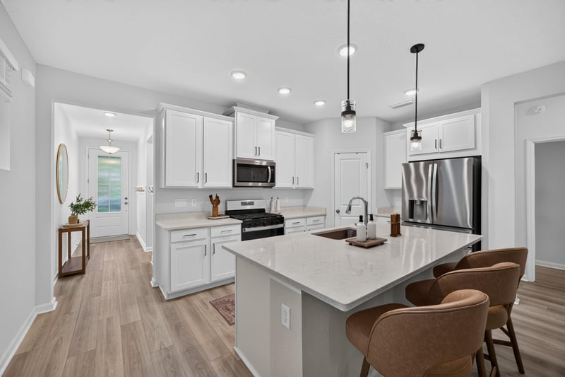 Kitchen view toward entry with quartz island at 93 Lochloosa Ct, St. Johns, FL 32259