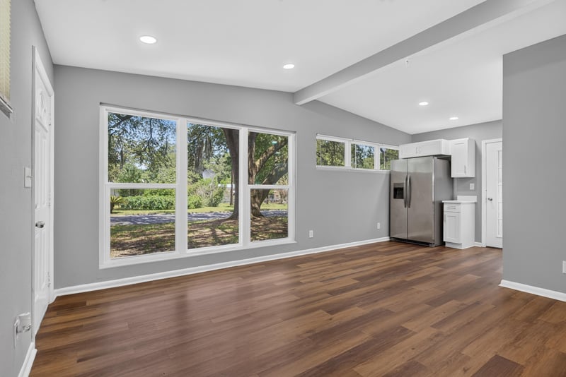 Living area with windows and kitchen beyond at 1928 Montmarte Dr, Jacksonville, FL 32210