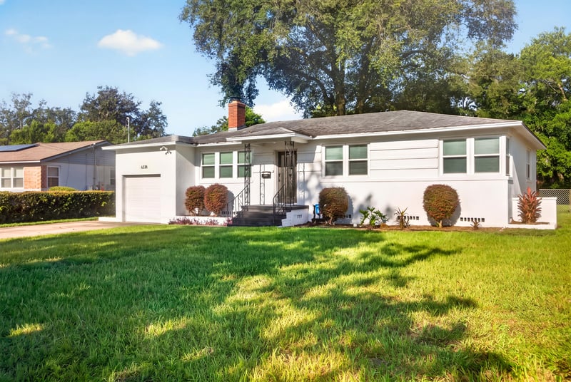 Front exterior with entry walkway and shutters at 6338 Mercer Cir W, Jacksonville, FL