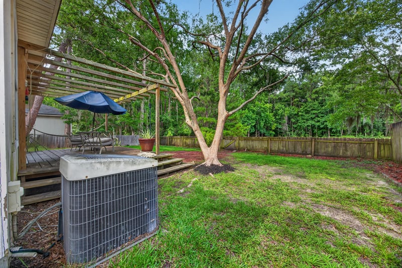 Backyard with hanging chair and AC unit at 145 Dover Bluff Dr, Orange Park, FL