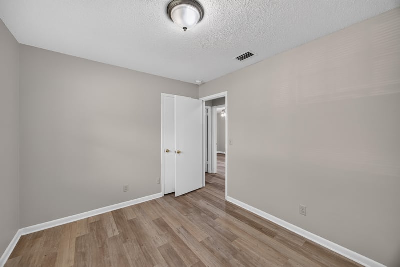 Bedroom with window and wood-look flooring at 12351 Condor Dr