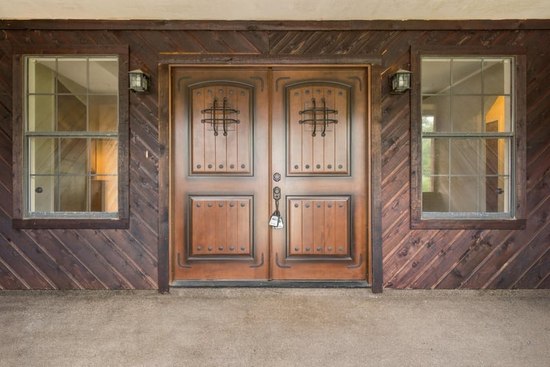 Close view of double wood front doors with glass panels at 2915 Trenton Ct, Orange Park, FL