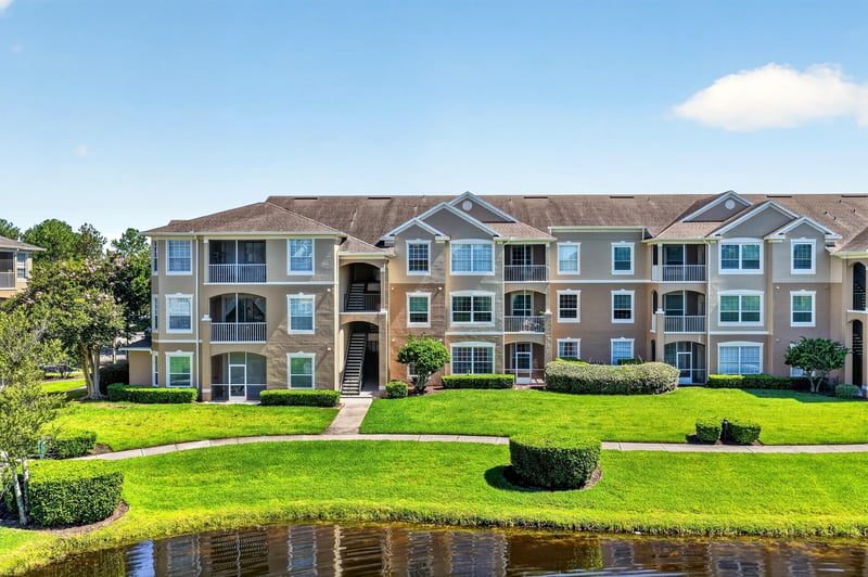 Condo building with landscaped walkway at 7990 Baymeadows Rd E #404, Jacksonville, FL 32256