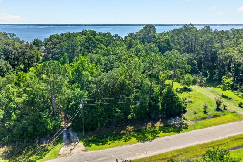 Low aerial view of the road and power lines near the lot at 110 River Shores Rd, Palatka, FL 32043
