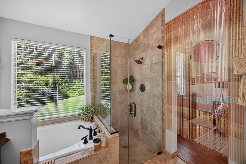 Bathroom with separate glass shower and tub at 1820 Burgess Hill Dr E, Jacksonville, FL