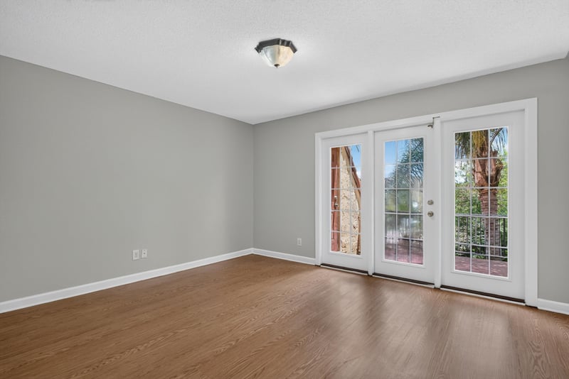 Bedroom with French doors and wood floor at 3866 Campenero Ct unit 6, Jacksonville, FL 32217