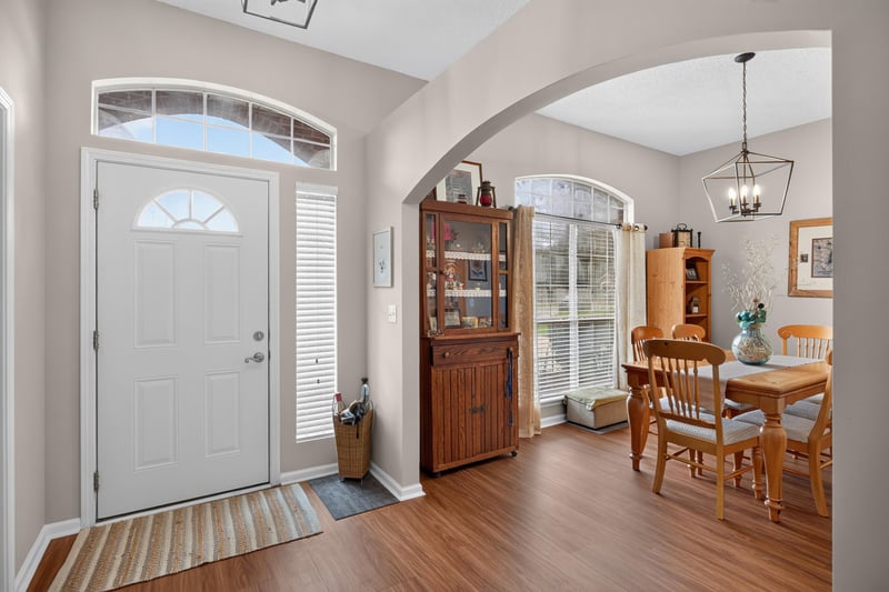 Entry foyer with wood floors and arched doorway at 13514 Las Brisas Way N, Jacksonville, FL