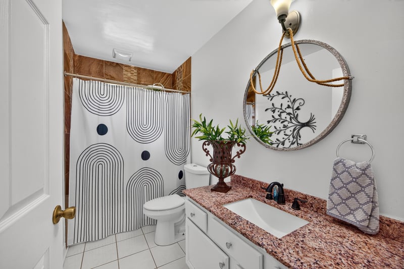 Bathroom with pedestal sink and mirror at 1346 Gately Ct, Jacksonville, FL 32225