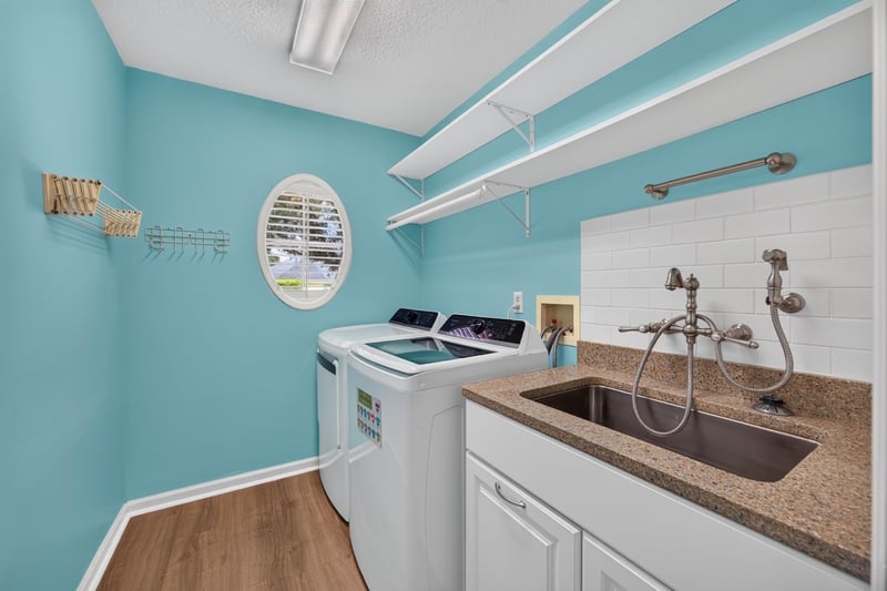 Laundry room with sink and teal walls at 1955 GUARDED Way, Fleming Island, FL 32003