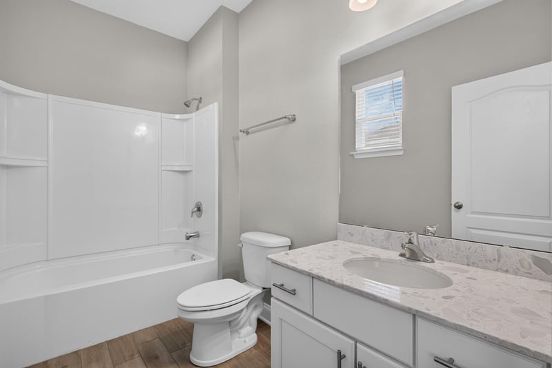 Bathroom with tub-shower combo and window at 2580 Cold Stream Ln, Green Cove Springs, FL 32043