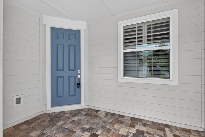Front door with paver entry and sidelight window at 171 Oyster Shell Ter, Nocatee, FL 32081