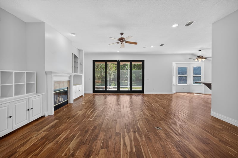 Living room with white built-ins and wood floors at 11675 Magnolia Estates Rd, Jacksonville, FL 32223