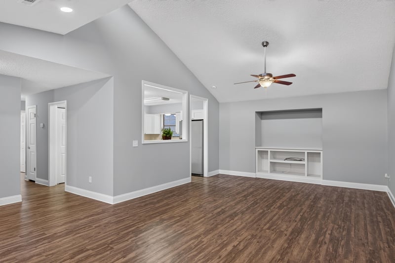 Open living area with vaulted ceiling and pass-through window at 12344 Cormorant Ct, Jacksonville, FL