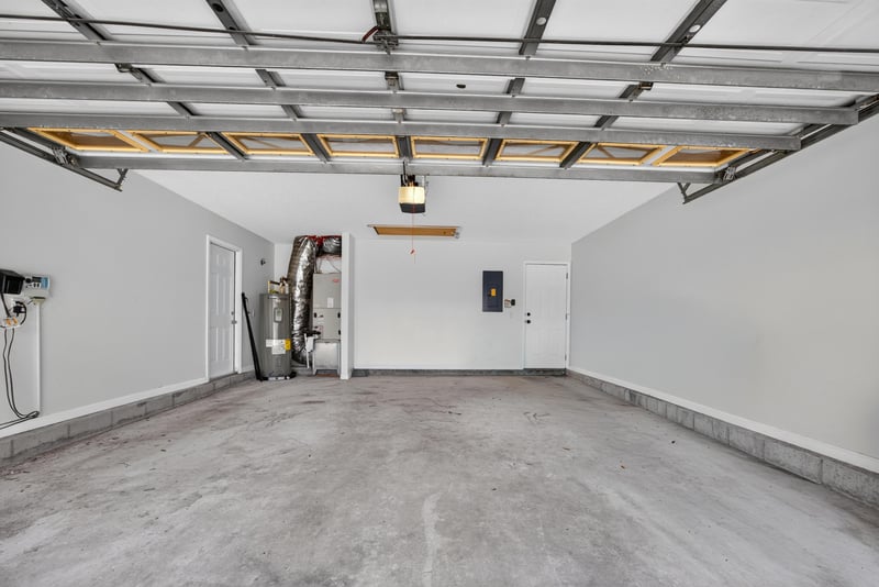 Two-car garage interior with concrete flooring at 2480 Ridge Will Dr, Jacksonville, FL 32246