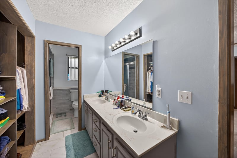 Bathroom vanity with walk-in closet access at 981 Marble Ridge Dr, Orange Park, FL 32065