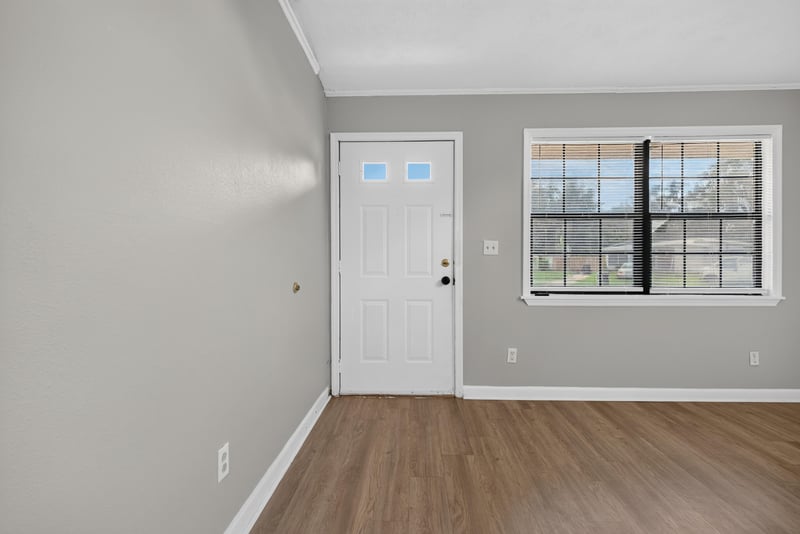 Living room with back door and two windows at 255 Woodside Dr, Orange Park, FL 32073