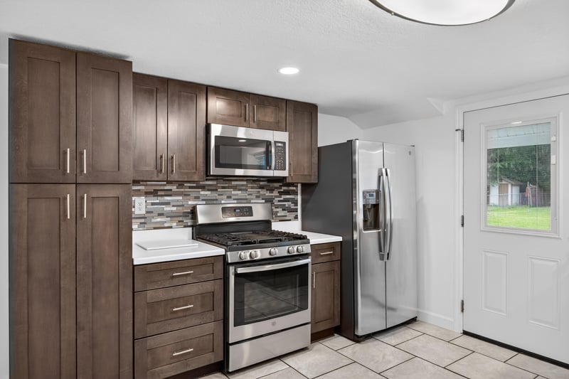 Kitchen with stainless range and dark wood cabinets at 1619 Hammond Blvd, Jacksonville, FL