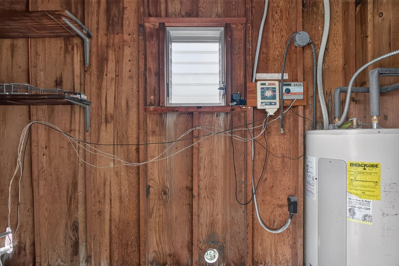 Utility area with wood paneling and water heater at 11462 Elane Dr, Jacksonville, FL