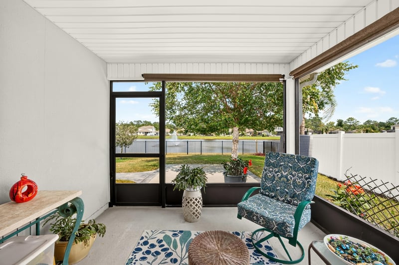 Screened lanai view toward backyard and lake at 85 Amia Dr, St. Augustine, FL 32086