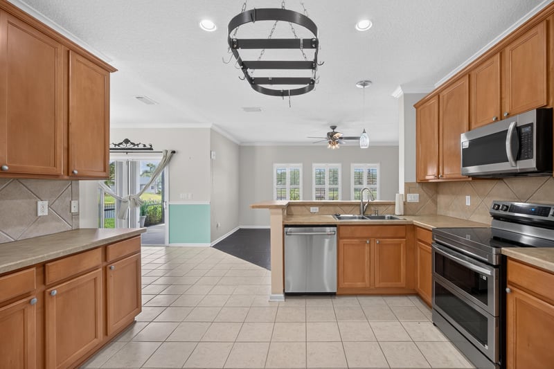Kitchen with wood cabinets and tile floor at 1493 Greyfield Dr, St. Augustine, FL 32092