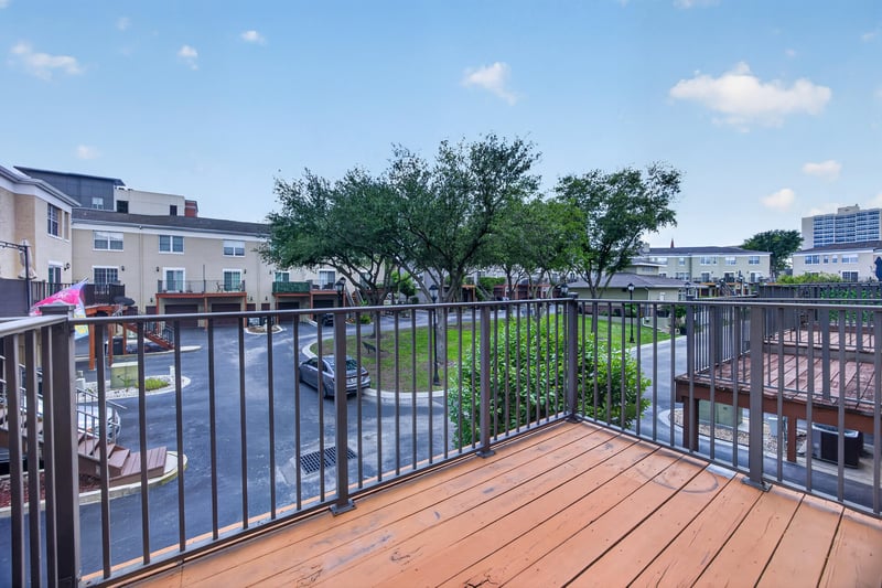 Wood deck with railing overlooking parking area at 342 E Ashley St, Jacksonville, FL 32202