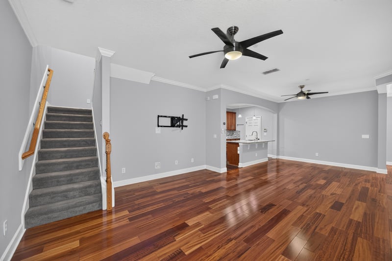 Living area with staircase and wood floors at 6217 Eclipse Cir, Jacksonville, FL 32258