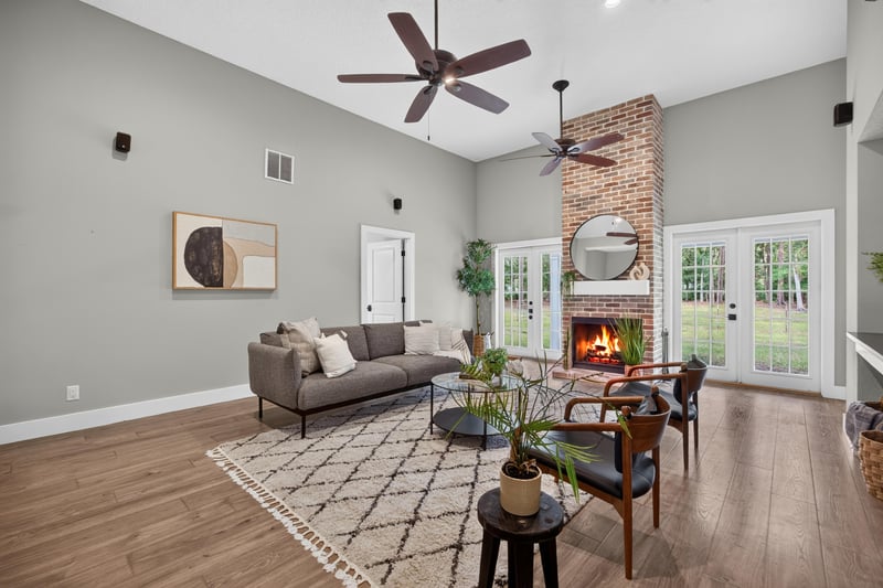 Living room with fireplace, sofa, and area rug at 1161 Whispering Pines Rd, Jacksonville, FL 32259