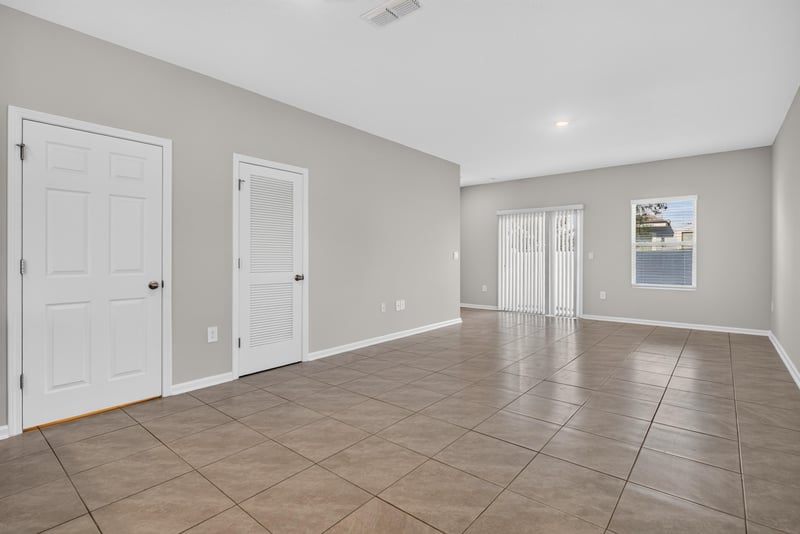 Open living area with tile floor and vaulted ceiling at 4024 Bay Hawk Ct, Jacksonville, FL