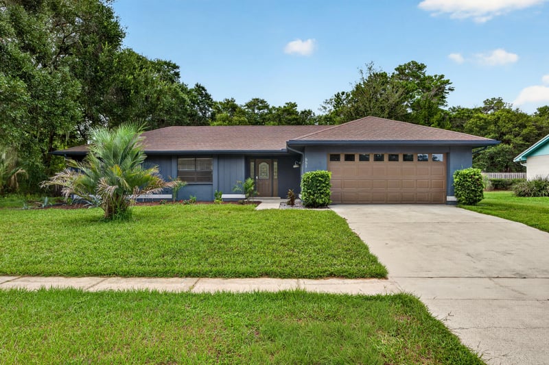 Front exterior angled view of driveway and entry at 551 Deltona Blvd, St. Augustine, FL 32086