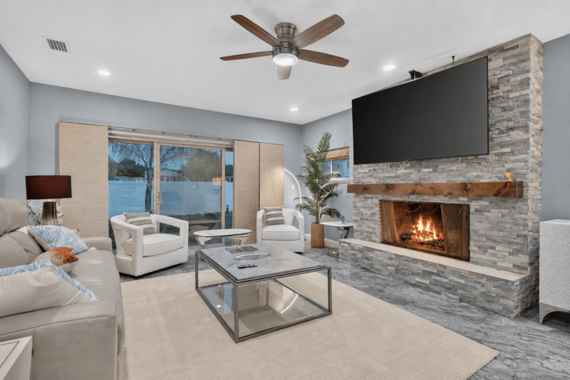 Living room with stone fireplace and seating at 1525 8th St N, Jacksonville Beach, FL