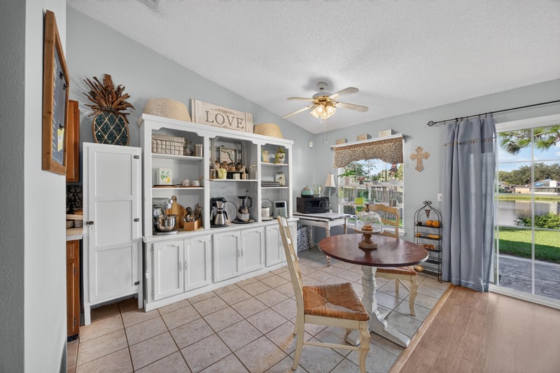Kitchen and dining area with white built-in cabinets at 4556 Shaky Leaf Ln N, Jacksonville, FL 32224