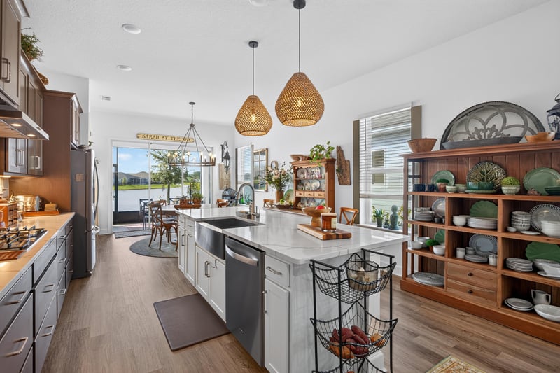 Kitchen island with pendant lights and pond view at 129 Amberwood Dr, St. Augustine, FL