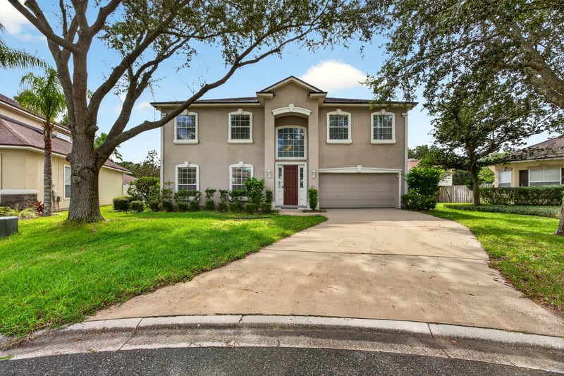 Front exterior with tile roof and curved driveway at 2875 Pebblewood Ln, Orange Park, FL 32065