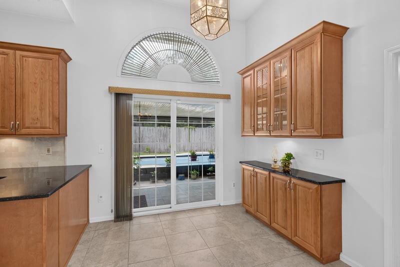 Kitchen with black granite counters and sliding door at 12810 Swamp Owl Ln
