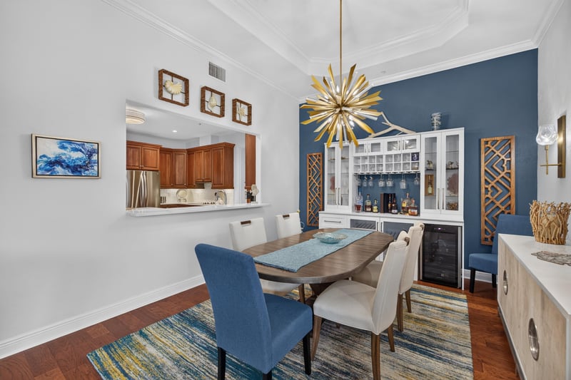Dining room with blue upholstered chairs and chandelier at 140 Ave De La Mer, Palm Coast, FL 32137
