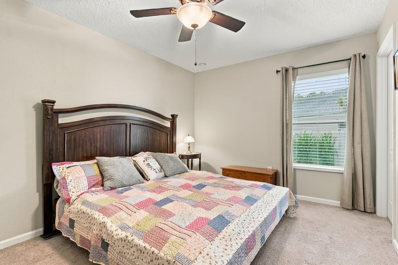 Secondary bedroom with bed and ceiling fan at 10923 Black Diamond Ct, Jacksonville, FL