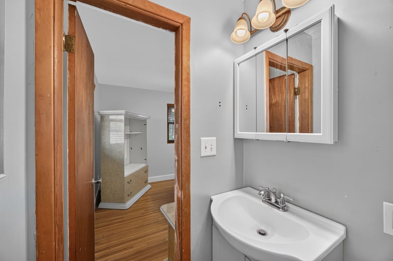 Hallway with bathroom sink and mirror visible at 1847 Grove Park Dr, Orange Park, FL