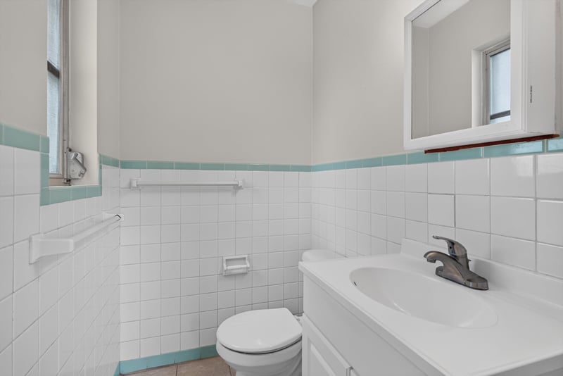 Bathroom with tile walls and window at 2618 Arlex Dr E, Jacksonville, FL