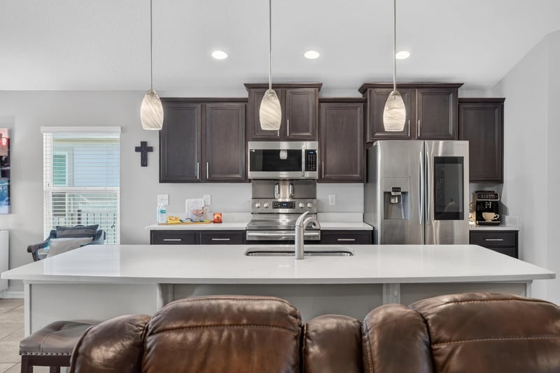 Kitchen with dark cabinets and stainless range at 589 Seville Pkwy, St. Augustine, FL