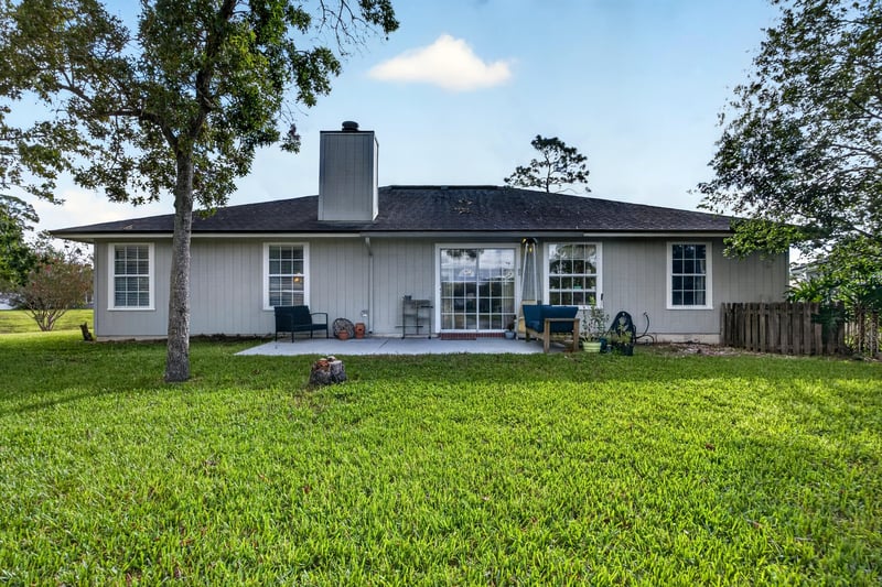 Rear exterior with patio and brick siding at 4556 Shaky Leaf Ln N, Jacksonville, FL 32224