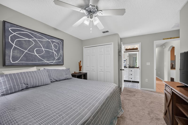 Bedroom with ceiling fan and large window at 2125 Blue Heron Cove Dr, Orange Park, FL 32003