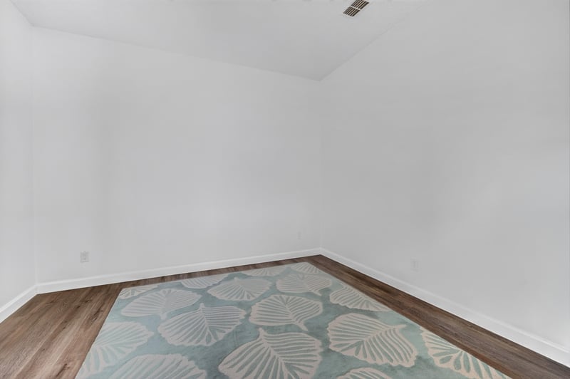 Empty room with area rug and wood floors at 8921 Needlepoint Pl, Jacksonville, FL 32244