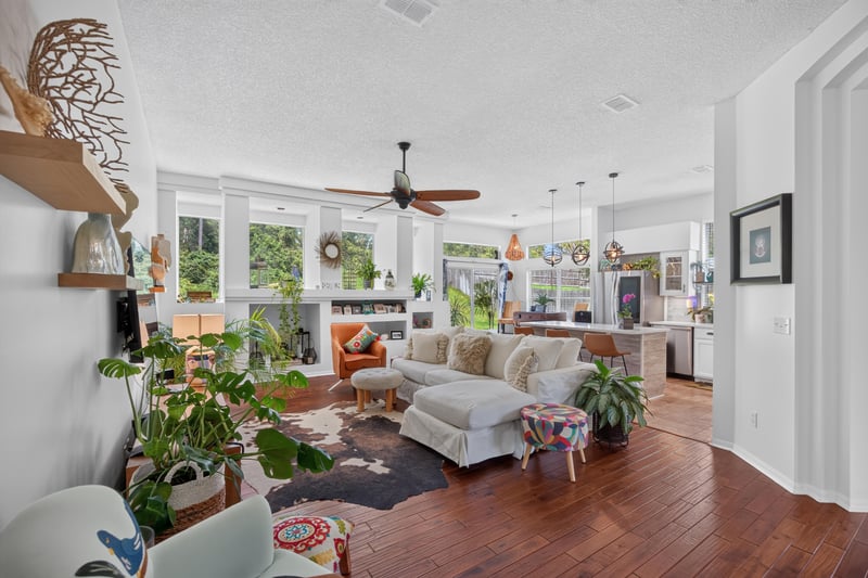 Family room open to kitchen with wood floors at 1820 Burgess Hill Dr E, Jacksonville, FL
