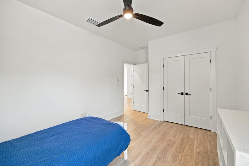 Bedroom with closet doors and blue bedding at 907 Seagrove Dr, Ponte Vedra Beach, FL 32081