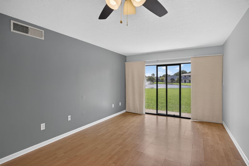 Living room facing sliding glass doors at 700 W Pope Rd unit h61, St. Augustine, FL 32080